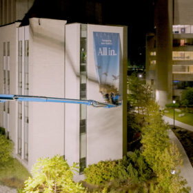 Installation of extra large vertical banners at Western University using an aerial lift
