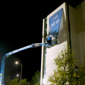 Installation of extra large vertical banners at Western University using an aerial lift