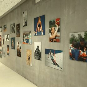 Photos installed on wall showcasing youth sports