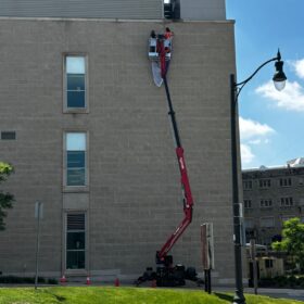Large format vertical banners being installed by technicians