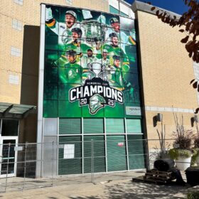 Technician Installing window graphics for London Knights